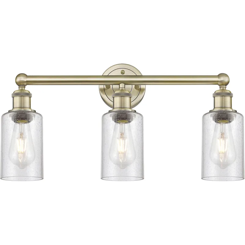 Clymer 3 Light 21.88 inch Antique Brass Bath Vanity Light Wall Light in Seedy Glass