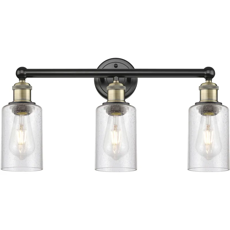 Clymer 3 Light 21.88 inch Black Antique Brass Bath Vanity Light Wall Light in Seedy Glass