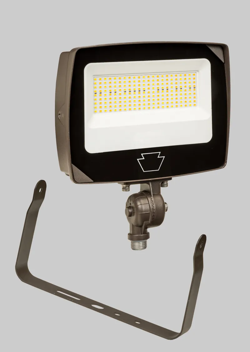35/25/15W LED Flood Light feat. Power Select & Color Select. Rectangular Series 4 with Built-in Photocell. 120-277V Input. 3000/4000/5000K. Standard Bronze Housing. Wide Flood, 7H x 7W Distribution. Knuckle and Yoke Mounts Included.